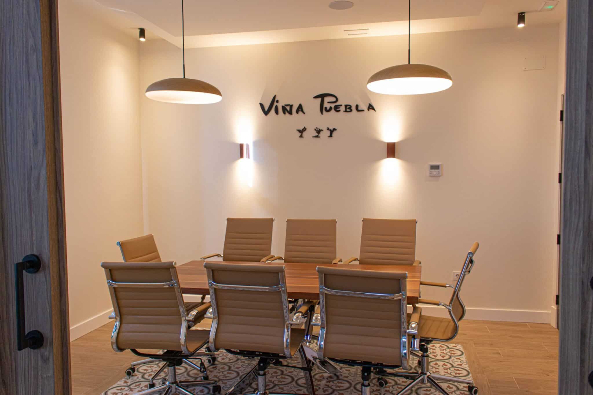 Sala de reuniones con el logo Viña Puebla en la pared